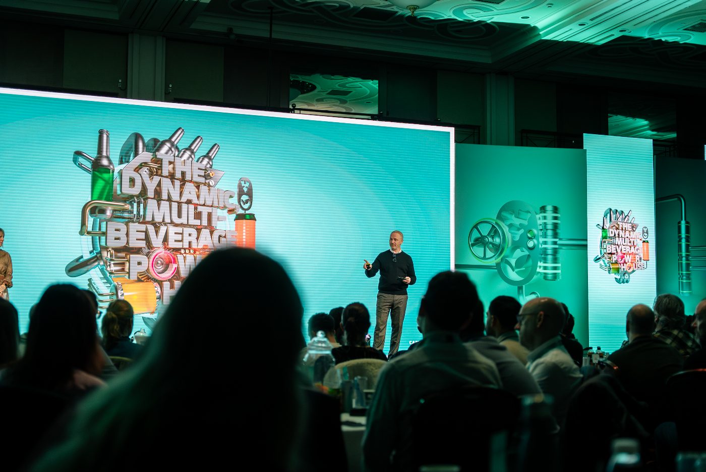 Someone presenting on stage at the carlsberg britvic event